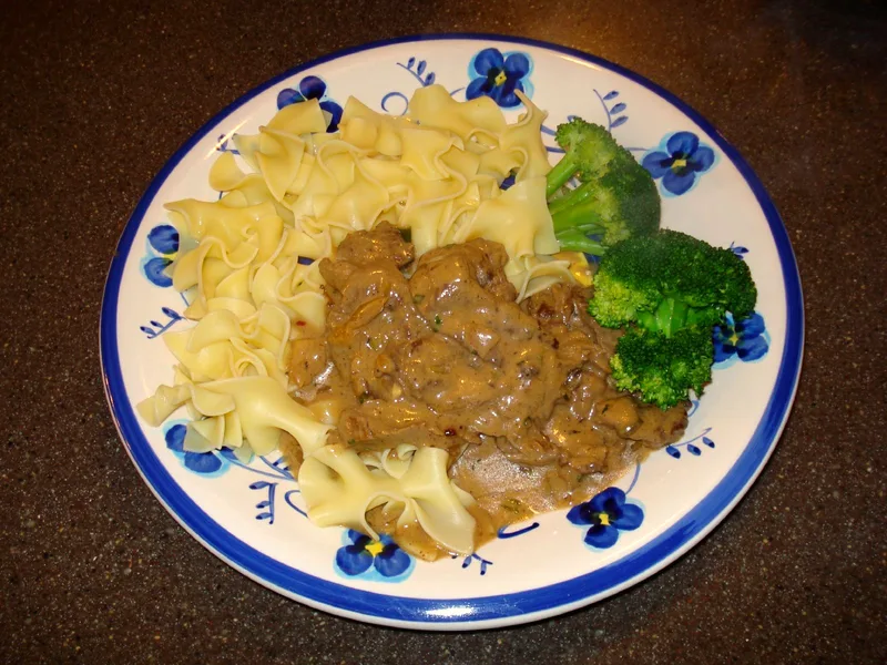 Slow cooker beef and noodles with tender chuck, mushrooms and rich gravy over egg noodles