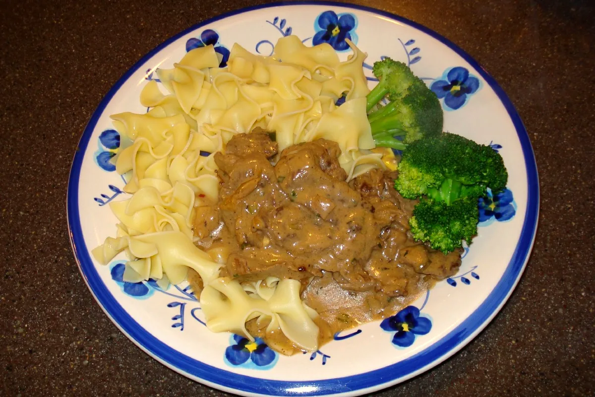 Slow cooker beef and noodles with tender chuck, mushrooms and rich gravy over egg noodles