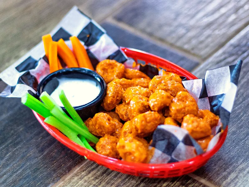 Easy baked buffalo cauliflower bites glazed in buffalo sauce with celery and ranch dip