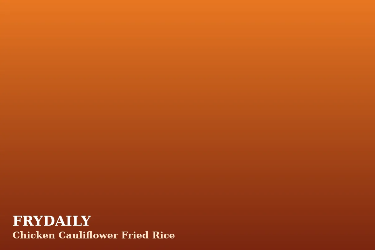 Chicken cauliflower fried rice in a bowl with peas, carrots, egg and green onions