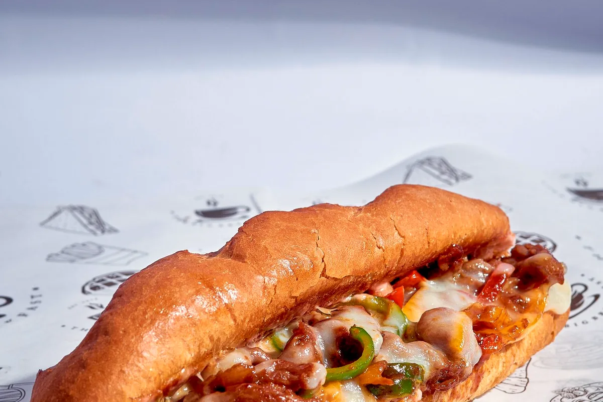Baked Philly cheesesteak casserole with melted provolone, peppers and onions