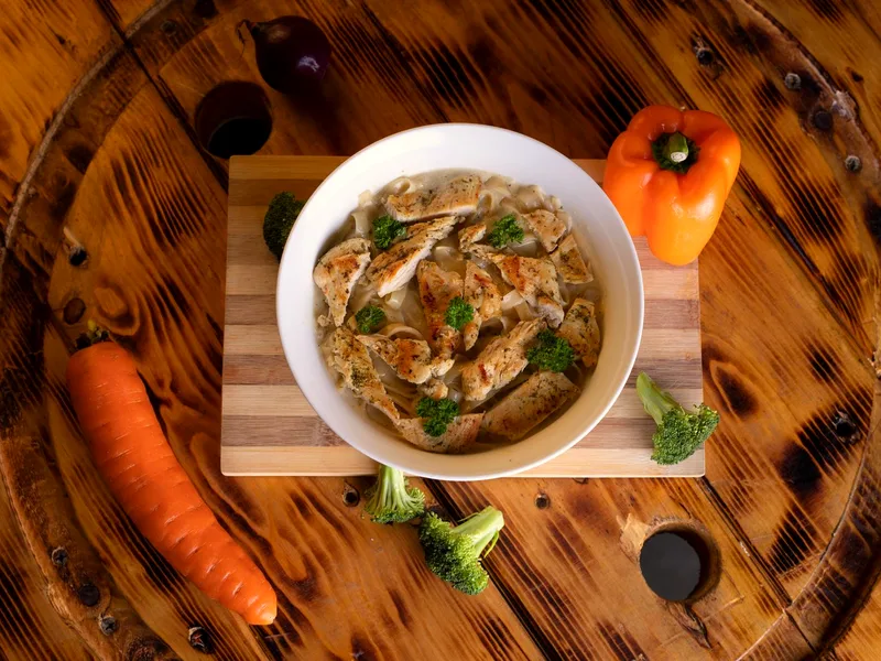 Slow cooker chicken and dumplings — a bowl of chicken soup with vegetables and dumplings