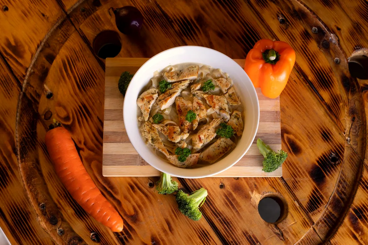 Slow cooker chicken and dumplings — a bowl of chicken soup with vegetables and dumplings