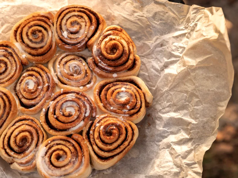 Protein cinnamon rolls with glossy glaze in a baking dish, fresh from the oven