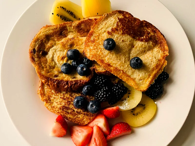 French toast with fresh blueberries and berries served for breakfast