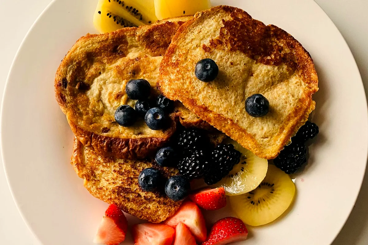 French toast with fresh blueberries and berries served for breakfast