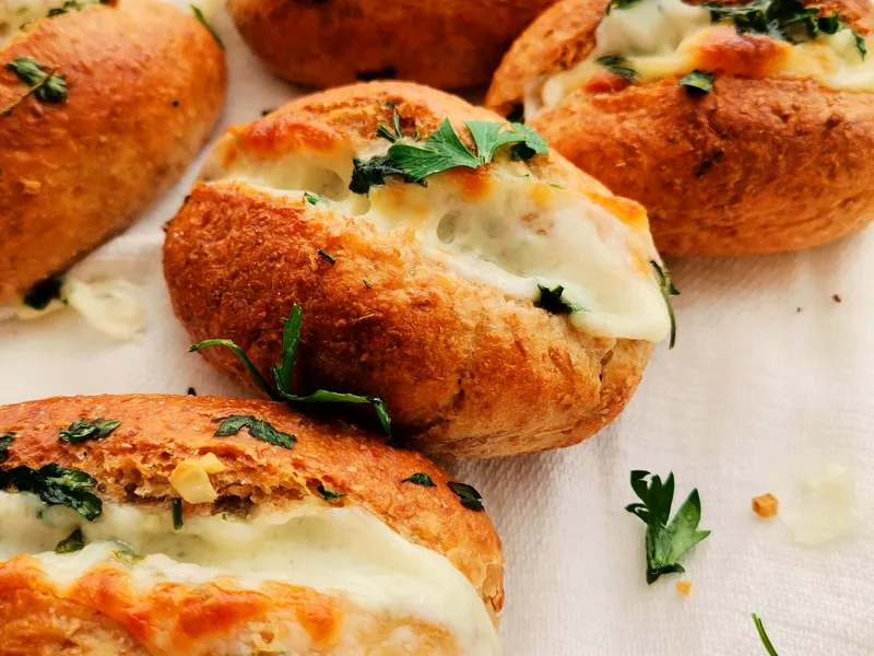Freshly baked garlic cheese breads garnished with fresh herbs