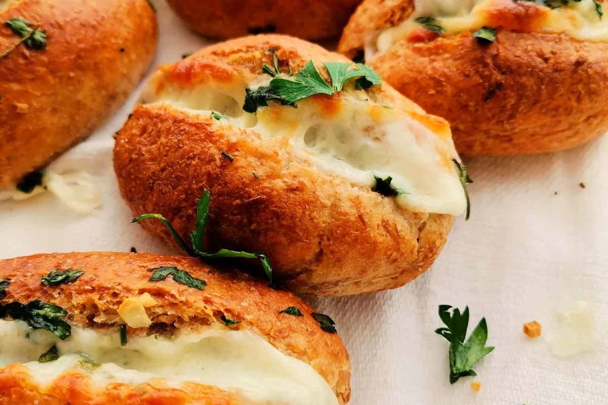 Freshly baked garlic cheese breads garnished with fresh herbs