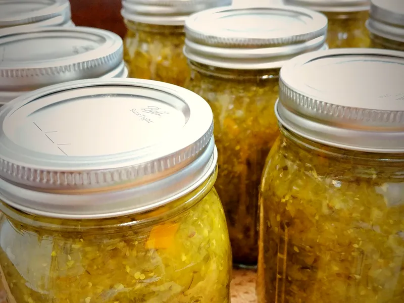 Easy refrigerator pickle relish with finely diced cucumber, peppers and mustard seeds in a jar