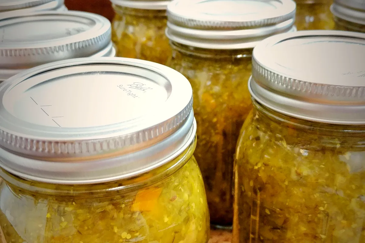 Easy refrigerator pickle relish with finely diced cucumber, peppers and mustard seeds in a jar