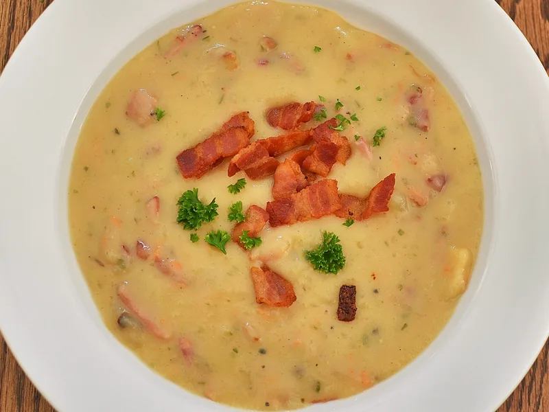 Slow cooker creamy potato soup topped with cheddar, bacon and green onions