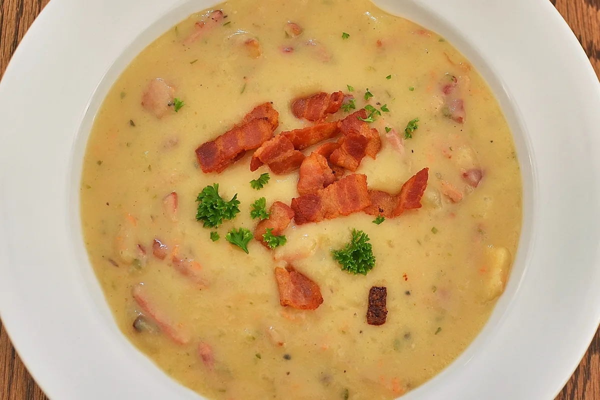 Slow cooker creamy potato soup topped with cheddar, bacon and green onions