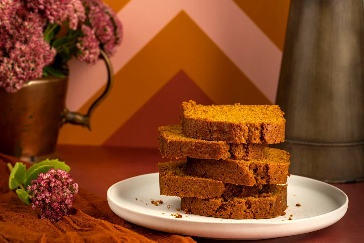 Easy chocolate chip pumpkin bread sliced on a board with chocolate chips melting in each slice