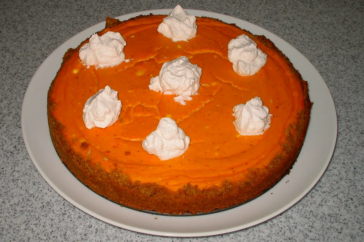 No-bake pumpkin cheesecake bars with spiced graham crust and whipped cream on top