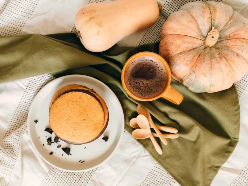 Pumpkin pancakes served with hot coffee and seasonal squash for a cozy fall breakfast