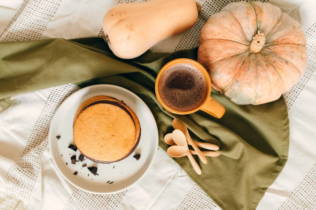 Pumpkin pancakes served with hot coffee and seasonal squash for a cozy fall breakfast