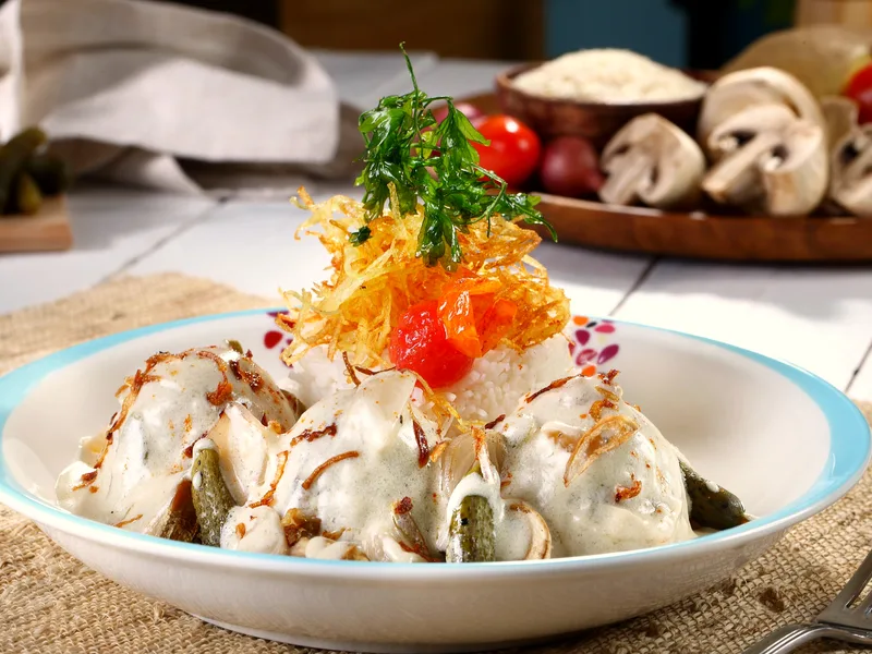 Slow cooker creamy ranch chicken shredded in a tangy cream cheese sauce with fresh herbs